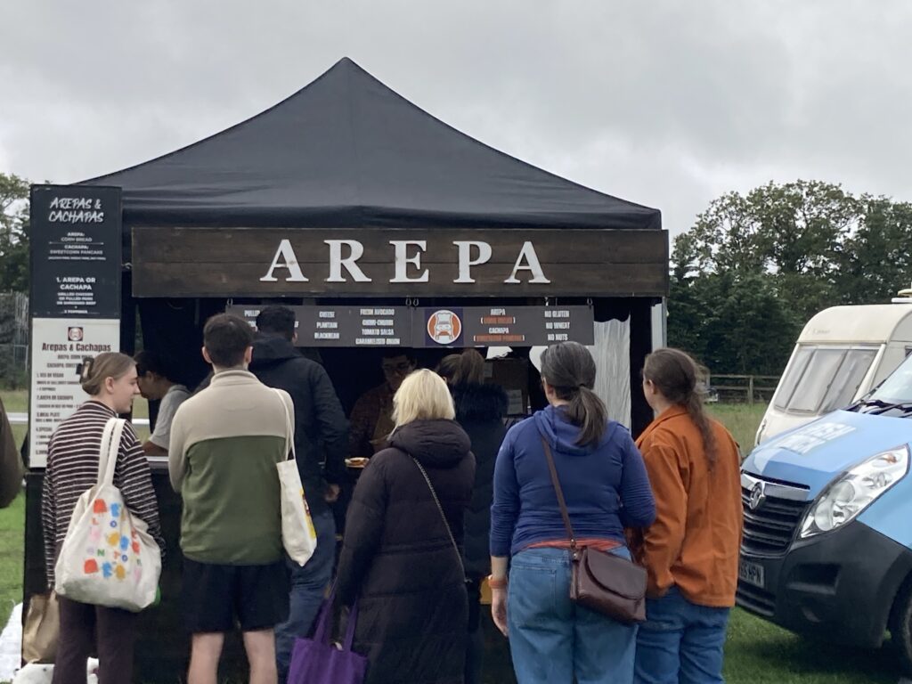 Visitors queuing at a gluten-free arepa and cachapa stall at the Free From Festival, Thornborough Events Field, Birmingham