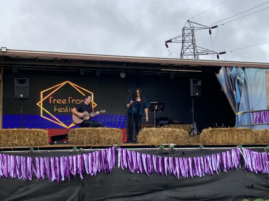 Guitarist and singer performing on the Free From Festival main stage, Thornborough Events Field, Birmingham